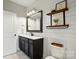 Stylish bathroom features shiplap wall, a dark vanity and toilet with wood accents at 5105 Paisano Ln, Waxhaw, NC 28173