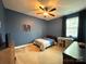 Comfortable bedroom is painted in blue with a large window and ceiling fan at 5105 Paisano Ln, Waxhaw, NC 28173