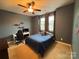 Comfortable bedroom is painted in blue with a large window and ceiling fan at 5105 Paisano Ln, Waxhaw, NC 28173