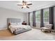 Spacious bedroom with a tray ceiling, lots of natural light and a cozy armchair at 5105 Paisano Ln, Waxhaw, NC 28173