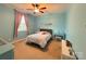 Comfortable bedroom is painted in blue with a large window and ceiling fan at 5105 Paisano Ln, Waxhaw, NC 28173