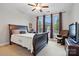 Bright bedroom with a sleigh bed, ceiling fan, and large windows at 5105 Paisano Ln, Waxhaw, NC 28173