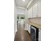 Butler's pantry with wine fridge, granite countertop and backyard view at 5105 Paisano Ln, Waxhaw, NC 28173