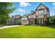 Beautiful two-story home with stone accents, three-car garage and lush green lawn at 5105 Paisano Ln, Waxhaw, NC 28173