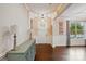 Bright entryway boasting dark hardwood floors, decorative wainscoting, and a view of the living area at 5105 Paisano Ln, Waxhaw, NC 28173