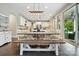Eat-in kitchen and dining area filled with natural light, with an expansive island and stainless steel appliances at 5105 Paisano Ln, Waxhaw, NC 28173