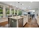 Gourmet kitchen featuring a spacious island with seating, granite countertops, and stainless steel appliances at 5105 Paisano Ln, Waxhaw, NC 28173