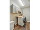 Well-organized laundry room with overhead cabinets and folding table at 5105 Paisano Ln, Waxhaw, NC 28173