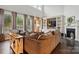 Open concept living room featuring a fireplace, built-ins, and large windows at 5105 Paisano Ln, Waxhaw, NC 28173