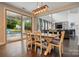Open-concept living and dining area with hardwood floors, large sliding glass doors, and comfortable seating at 5105 Paisano Ln, Waxhaw, NC 28173