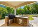 Well-equipped outdoor kitchen with a built-in grill and stainless steel storage, perfect for entertaining at 5105 Paisano Ln, Waxhaw, NC 28173
