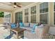 Relaxing covered patio area with comfortable seating and a ceiling fan for outdoor enjoyment at 5105 Paisano Ln, Waxhaw, NC 28173