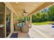 Spacious covered patio with outdoor seating, a ceiling fan, and a view of the lush backyard at 5105 Paisano Ln, Waxhaw, NC 28173