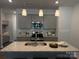 Modern kitchen with stainless steel appliances, gray cabinetry, and granite countertops on the island at 5817 Tuckaseegee Rd, Charlotte, NC 28208