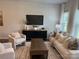 Cozy living room with stylish furniture, TV, and neutral decor throughout the space at 5817 Tuckaseegee Rd, Charlotte, NC 28208
