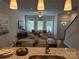 An open-concept dining and living room with hardwood floors and large bright windows at 5817 Tuckaseegee Rd, Charlotte, NC 28208