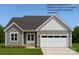 A charming single story home with a two car garage and light gray siding under a dark gray roof at 6203 Flay Rd, Cherryville, NC 28021