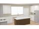 Bright kitchen with white cabinetry, stainless appliances, and center island at 6203 Flay Rd, Cherryville, NC 28021