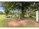 Expansive backyard featuring mature trees, a rustic fire pit, and garden beds, ideal for outdoor enjoyment at 733 Osteen Rd, York, SC 29745