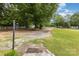 Inviting front yard with mature trees, white fence, gravel drive, and a warm welcome at 733 Osteen Rd, York, SC 29745