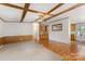 Bright open-concept living room boasts wood floors, exposed beams and flows into the kitchen at 733 Osteen Rd, York, SC 29745