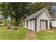 A stylish outbuilding features a metal roof, garage door, swing and decorative touches at 733 Osteen Rd, York, SC 29745