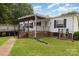 Charming home with covered porch, brick accents, and a spacious deck, perfect for outdoor entertaining at 733 Osteen Rd, York, SC 29745