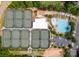 Overhead view of community tennis courts and pool facility with vibrant umbrellas surrounded by trees at 8005 Island View Ct, Denver, NC 28037
