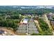 Aerial view of community tennis courts and pool, surrounded by lush trees and homes near Lake Norman at 8005 Island View Ct, Denver, NC 28037