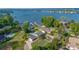 Stunning aerial view of a lakeside property with mature trees, a pool, and multiple docks at 8005 Island View Ct, Denver, NC 28037