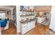 Stylish bar area with open shelving, storage, and views into the adjacent kitchen at 8005 Island View Ct, Denver, NC 28037