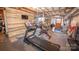 Spacious basement home gym featuring exercise equipment and tv with wood paneled wall at 8005 Island View Ct, Denver, NC 28037