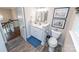 Well-lit bathroom with a white vanity, wood-look flooring, and tasteful decor at 8005 Island View Ct, Denver, NC 28037