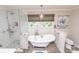 Bathroom featuring a clawfoot tub, separate shower, and large window for ample natural light at 8005 Island View Ct, Denver, NC 28037