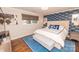 Charming bedroom features hardwood floors, blue accent wall, and upholstered headboard at 8005 Island View Ct, Denver, NC 28037