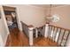 Entryway with hardwood floors, wrought iron railing, and contemporary light fixture at 8005 Island View Ct, Denver, NC 28037