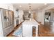 Bright kitchen with a large central island, stainless steel fridge, and white cabinetry at 8005 Island View Ct, Denver, NC 28037