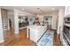 Open-concept kitchen features a center island with seating and connects to dining area at 8005 Island View Ct, Denver, NC 28037