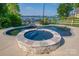 Close-up view of a uniquely designed pool featuring a stone-accented hot tub and dark tile at 8005 Island View Ct, Denver, NC 28037