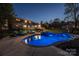 Twilight shot of a stunning pool with LED lighting illuminating the patio of this brick two-story home at 8005 Island View Ct, Denver, NC 28037