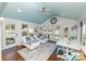 Relaxing sun room with vaulted ceiling, ceiling fan, and white wicker furniture at 8005 Island View Ct, Denver, NC 28037