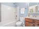 Clean bathroom featuring a shower-tub combo with white tile and a vanity with modern fixtures at 8033 Pawleys Ct, Fort Mill, SC 29707