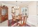 Charming dining room with classic furniture, a large window, and decorative wall trim at 8033 Pawleys Ct, Fort Mill, SC 29707