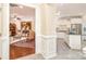 Bright foyer leading to a modern kitchen and living room with hardwood floors and detailed trim work at 8033 Pawleys Ct, Fort Mill, SC 29707