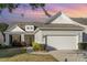 Charming home with a two-car garage, manicured landscaping, and a welcoming front porch at 8033 Pawleys Ct, Fort Mill, SC 29707
