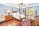 Spacious main bedroom with hardwood floors, canopy bed, and natural light at 8033 Pawleys Ct, Fort Mill, SC 29707