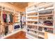 Organized walk-in closet with custom shelving and storage solutions for clothing and accessories at 8033 Pawleys Ct, Fort Mill, SC 29707