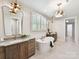 Bright bathroom with soaking tub, double vanities, and modern lighting at 8108 Farm Crossing Ln # 26, Huntersville, NC 28078