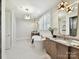 Bright bathroom features a soaking tub, marble countertops, and modern gold fixtures at 8108 Farm Crossing Ln # 26, Huntersville, NC 28078