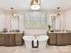 Luxurious bathroom featuring a soaking tub, double vanities, elegant lighting, and bright windows at 8108 Farm Crossing Ln # 26, Huntersville, NC 28078